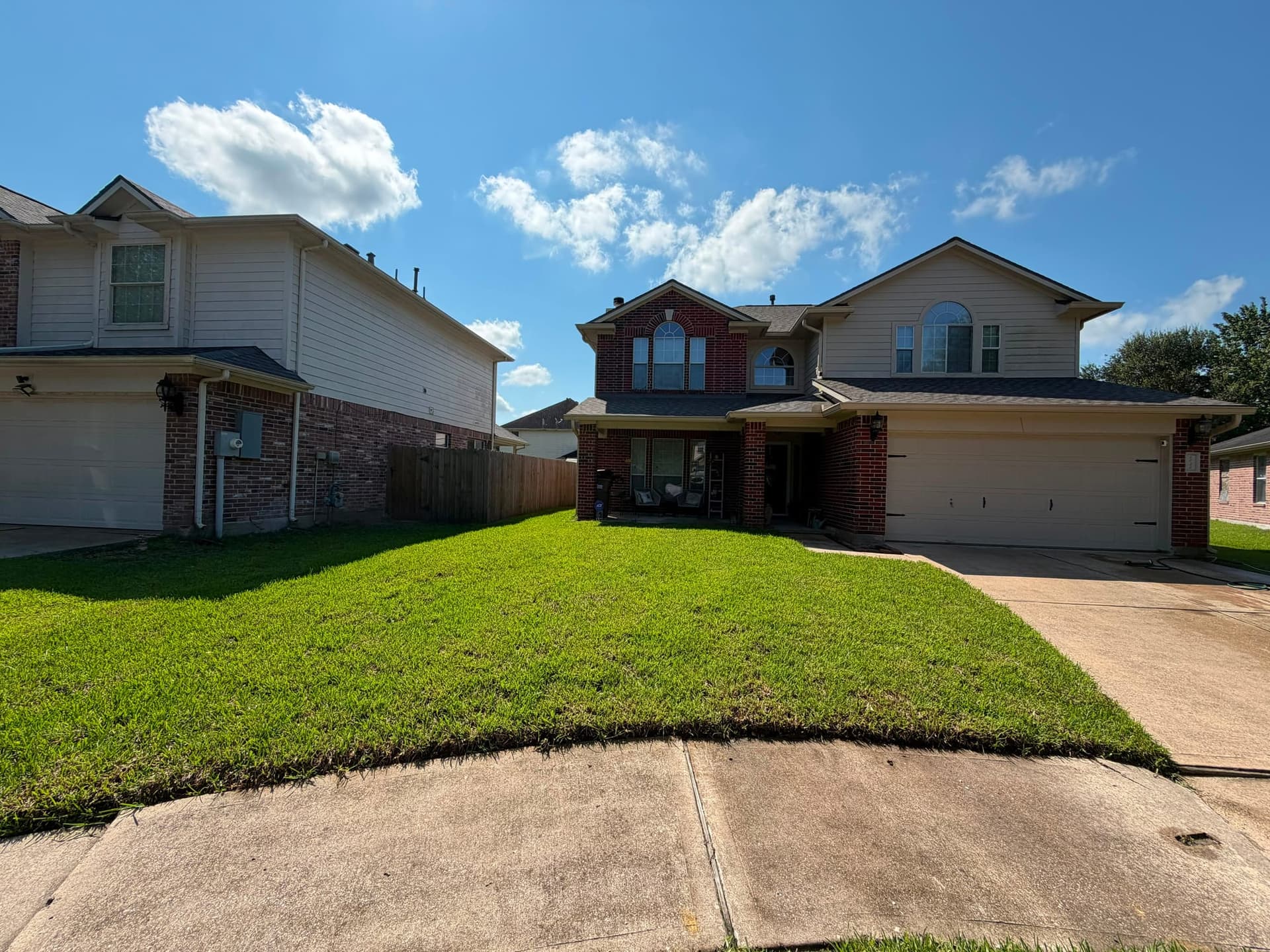 Thick green front lawn covering the full yard after sod installation
